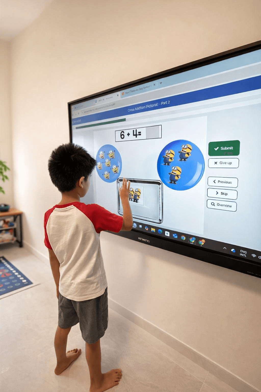 A child working through an addition activity on a large interactive touchscreen at Inclusive Kids Club